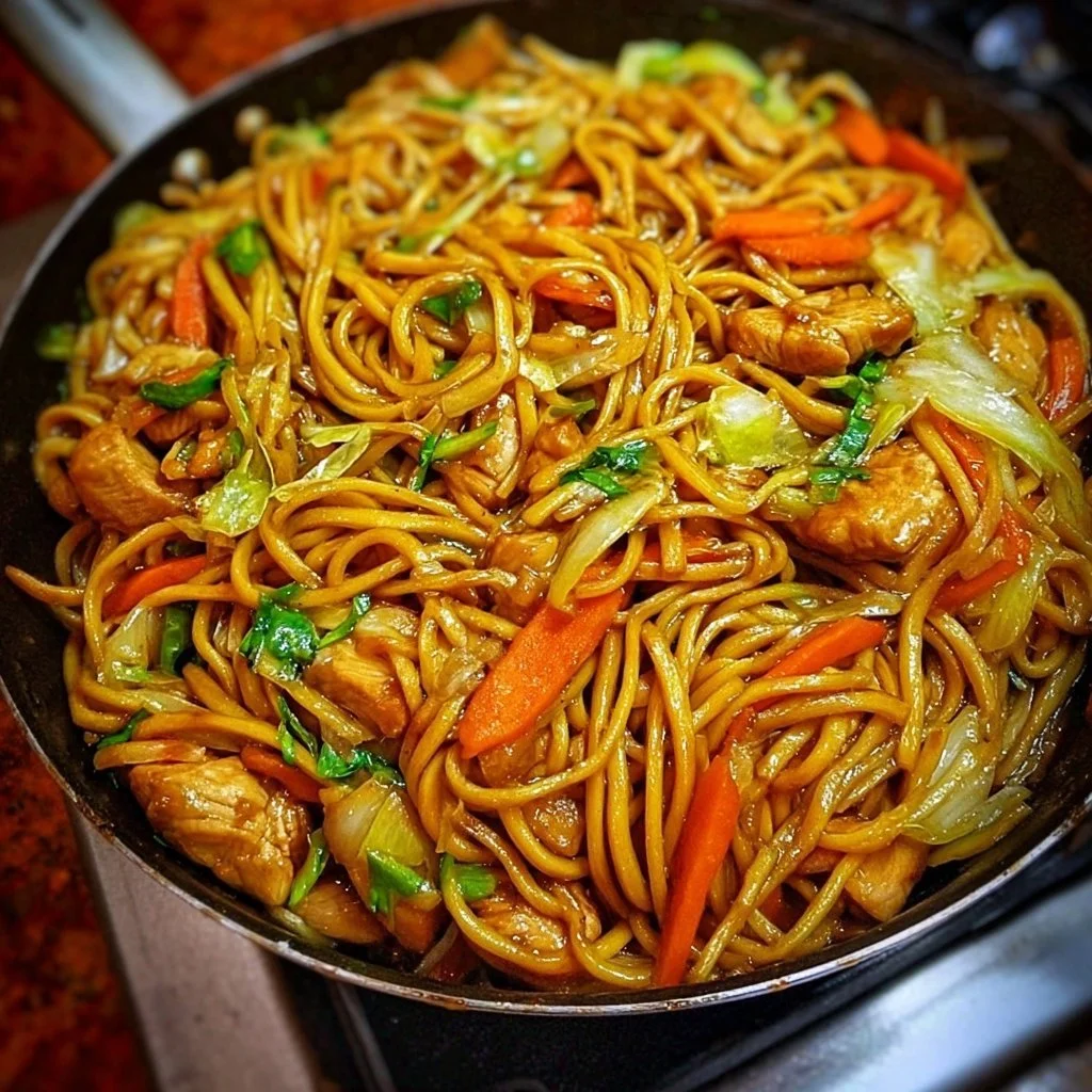 A bowl of Chicken Lo Mein with vegetables and chicken over noodles