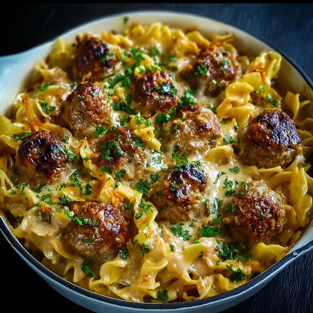 Swedish Meatball Noodle Bake 3 Swedish Meatball Noodle Bake topped with cheese and herbs in a baking dish