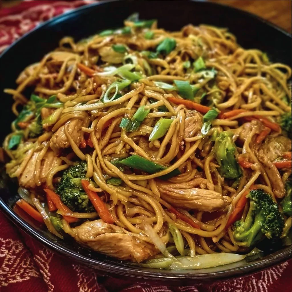 A bowl of gluten-free Chicken Lo Mein with colorful vegetables and chicken