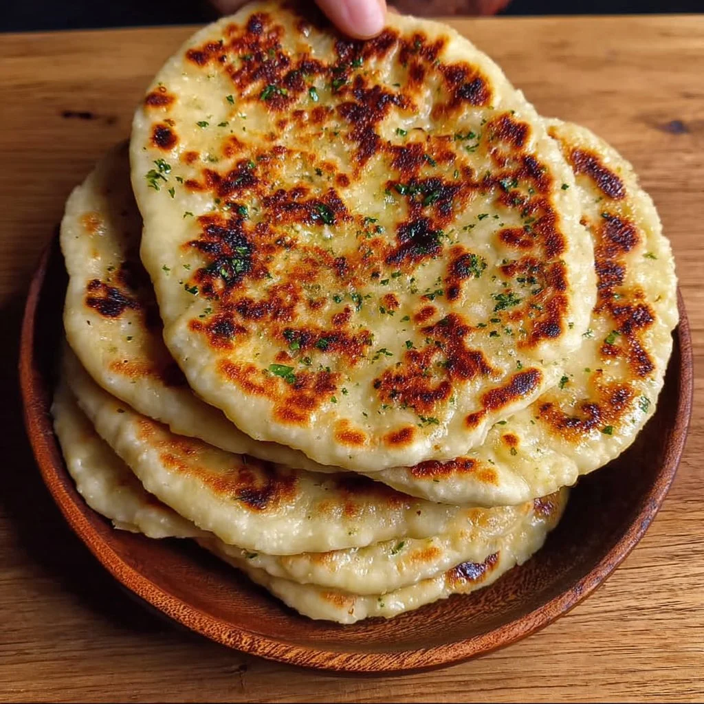 Delicious high protein cheesy garlic naans served warm.